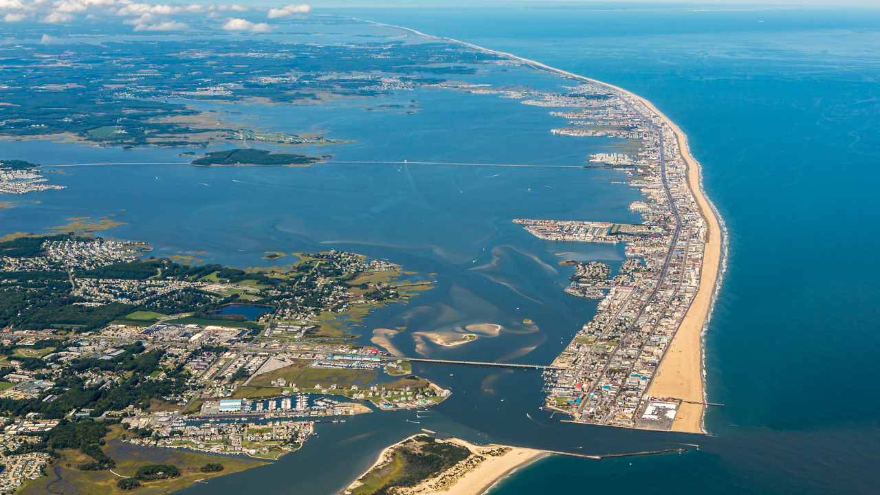 how-much-does-a-vacation-rental-in-ocean-city-md-cost-The-Different-Areas-of-Ocean-City-MD-6a29be849f795.png Aerial view showing the different areas of Ocean City, Maryland from the Inlet to the Delaware line
