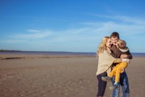 family on beach in fall