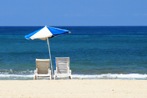 top-6-fun-things-to-do-in-ocean-city-md-beach-umbrella-300x200-6a29be870c746.png two chairs under an umbrella on the beach in Ocean City, MD