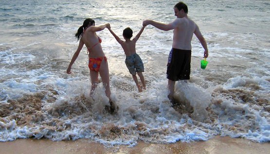 family playing in the ocean