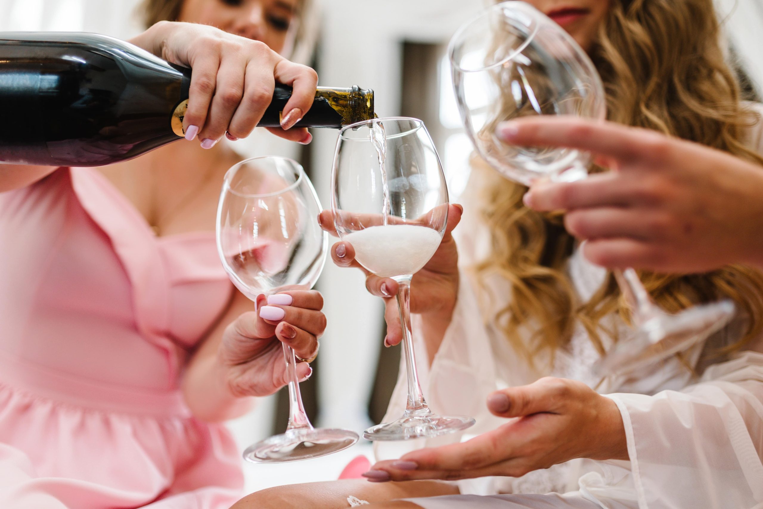 Picture of girls pouring champagne into glasses.
