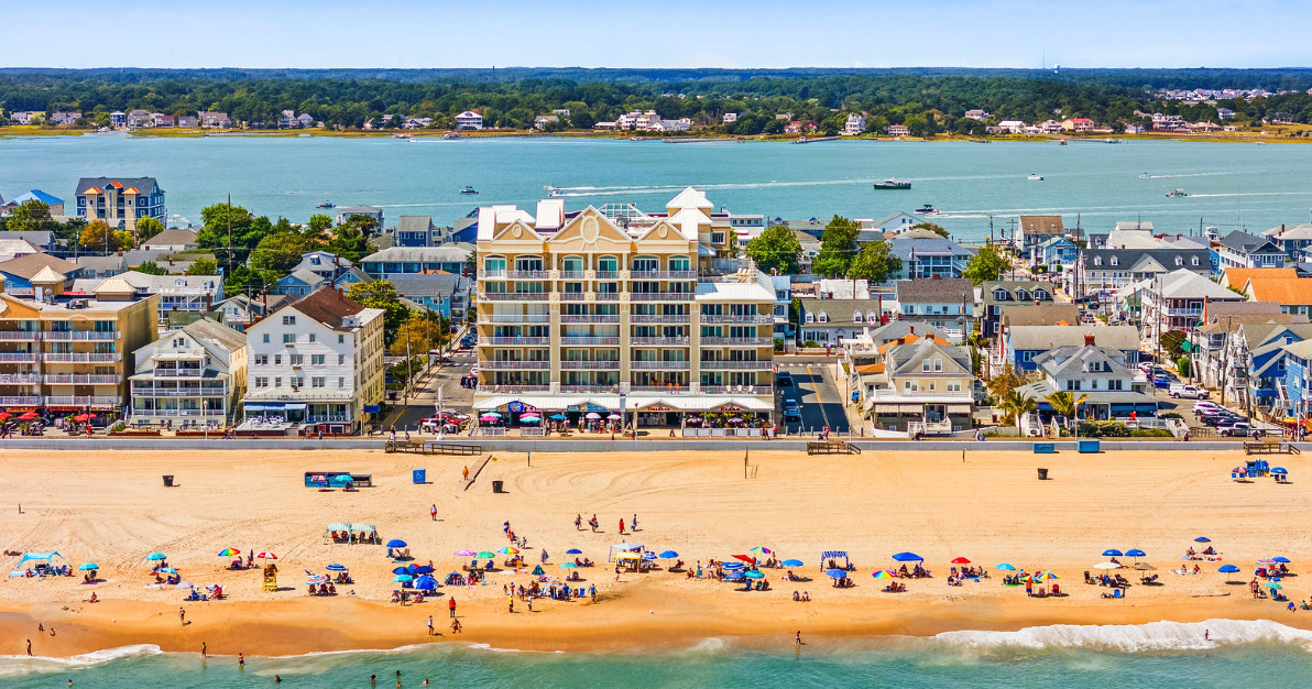 Family enjoying an Ocean City MD beach vacation with the boardwalk in the background
