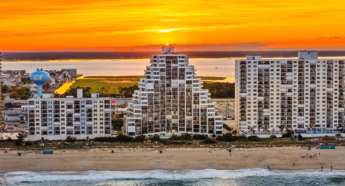 Ocean City MD oceanfront condos along the coastline at sunset
