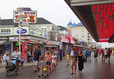 Ocean City MD summer beach scene with boardwalk and families